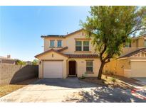 Inviting two-story home with a well-manicured front yard, garage, and desert landscaping at 10254 Martinsburg Ct, Las Vegas, NV 89183