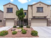 Charming townhome featuring desert landscaping, stone accents, and private gated entry, located in a desirable neighborhood at 1604 Patrick Thomas Ct, North Las Vegas, NV 89086