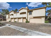 Attractive townhomes boast desert landscaping, charming exteriors, and private garages for easy living at 2050 W Warm Springs Rd # 3211, Henderson, NV 89014