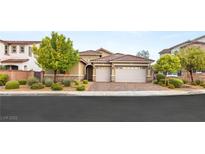 Charming single-story home featuring a two-car garage, well-maintained landscaping, and a red tile roof at 2116 Canvas Edge Dr, Henderson, NV 89044