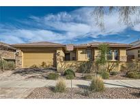 Charming single-story home with a well-manicured lawn, desert landscaping, and an attached two-car garage at 262 Inflection St, Henderson, NV 89011