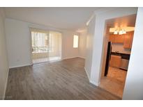 Bright living room featuring wood floors and access to outdoor balcony at 270 E Flamingo Rd # 136, Las Vegas, NV 89169