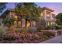 Elegant home featuring a desert landscape, stone accents and a balcony at 3010 Hammerwood Dr, Las Vegas, NV 89135