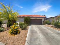 Charming single-story home featuring a red tile roof, a well maintained yard and a two-car garage at 3142 Espanol Dr, Las Vegas, NV 89121