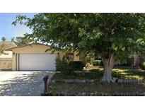 Charming single-story home featuring an attached two-car garage and a spacious front yard with mature landscaping at 3536 Anthony Dr, Las Vegas, NV 89121