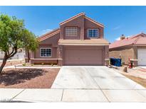 Charming two-story home features a well-maintained yard and a spacious two-car garage, inviting appeal at 3547 Empress Diamond Dr, North Las Vegas, NV 89032