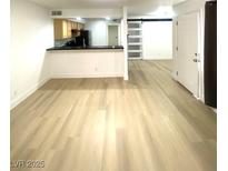Spacious living room boasts modern flooring and leads to an open kitchen area at 4248 Tara Ave # 2, Las Vegas, NV 89102