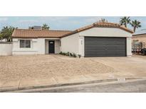 Charming single-story home with a low-maintenance front yard and attached two-car garage at 427 Wright Way, Henderson, NV 89015