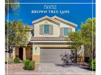 Charming two-story home featuring desert landscaping, a tile roof, and neutral-toned exterior paint at 5852 Brown Tree Ln, North Las Vegas, NV 89081