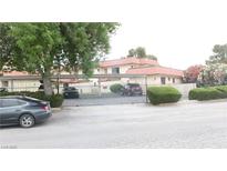 A gated community with mature trees and landscaping enhances curb appeal at 721 Bourbon St # F2, Pahrump, NV 89048