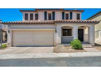 Charming two-story home with a two-car garage and landscaped front yard at 9165 Starling Wing Pl, Las Vegas, NV 89143