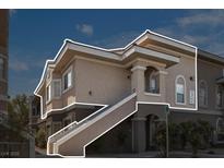Exterior view of a tan two-story condo with stairs outlined in white at 9330 W Maule Ave # 212, Las Vegas, NV 89148