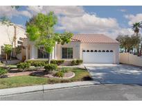 Charming single-story home with a tile roof, manicured lawn, and attached two-car garage at 9404 Calico Garden Ave, Las Vegas, NV 89134