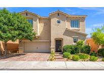 Charming two-story home with a well-manicured lawn, neutral stucco, and brick paver driveway at 9654 Ponderosa Skye Ct, Las Vegas, NV 89166