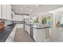 Bright, open kitchen with a large island, stainless steel appliances, and modern finishes at 9654 Ponderosa Skye Ct, Las Vegas, NV 89166