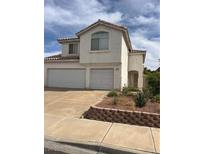Two-story home with a three-car garage and low-maintenance landscaping at 128 Appian Way, Henderson, NV 89002