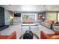 Spacious living room featuring modern gray walls, tile flooring, and large windows, creating an inviting space at 1521 Sombrero Dr, Las Vegas, NV 89169