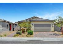 Charming single-story home featuring a paver driveway, desert landscaping, and a two-car garage at 2238 Thelen Ave, North Las Vegas, NV 89086