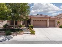 Charming single-story home with a three-car garage, tile roof and landscaped front yard with mature tree at 3522 Shonna Way, North Las Vegas, NV 89032