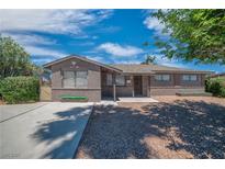 Charming single story home featuring brick veneer and desert landscaping at 416 Rossmoyne Ave, North Las Vegas, NV 89030