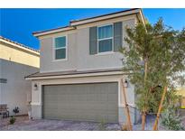 Charming two-story home featuring a two-car garage, landscaped yard, and a modern, neutral color palette at 4977 Birchland Manor Ave, Las Vegas, NV 89139