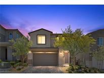Charming two-story home with a two-car garage and well-maintained landscaping at twilight at 55 Strada Fontana, Henderson, NV 89011