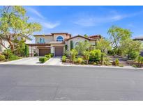 Elegant home with two-car garage, manicured landscaping, and a beautiful tile roof at 628 Chervil Valley Dr, Las Vegas, NV 89138