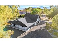 Stunning home exterior with lush landscaping, mountain views, and a large driveway at 6920 Bradley Rd, Las Vegas, NV 89131