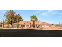 Charming single-story home showcasing desert landscaping, a terracotta roof, and a three-car garage at 7110 La Cienega St, Las Vegas, NV 89119
