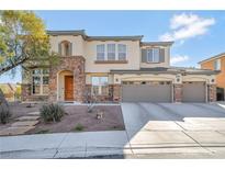 Inviting two-story home featuring a stone-accented facade and a spacious three-car garage at 7778 Villa Montara St, Las Vegas, NV 89123