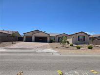 Inviting single-story home with a spacious three-car garage and desert landscaping for easy maintenance at 8665 Jerlyn St, Las Vegas, NV 89113