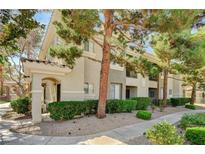 Attractive condominium building with well-maintained landscaping and mature trees at 9050 W Warm Springs Rd # 2051, Las Vegas, NV 89148