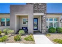 Inviting front entrance with stone accents, desert landscaping, and a cozy seating area at 924 Allister Fields Ln, Las Vegas, NV 89138