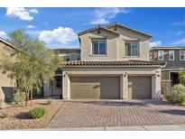 Charming two-story home boasts a 2-car garage and well-manicured landscaping at 10057 Matter Overlook Dr, Las Vegas, NV 89178