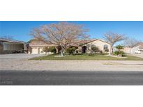 Attractive desert home with a well-manicured lawn and ample parking space at 10140 W Tropical Pkwy, Las Vegas, NV 89149