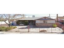 Charming single-story home featuring a brick facade and gated front yard, offering both curb appeal and security at 1120 Saylor Way, Las Vegas, NV 89108