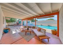 Inviting covered back patio with comfortable seating area and view of the sparkling pool at 1721 E Oakey Blvd, Las Vegas, NV 89104