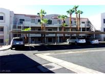 Apartment building featuring covered parking, palm trees, and modern architecture, perfect for convenient living at 2044 Mesquite Ln # 301, Laughlin, NV 89029
