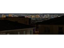 Striking Las Vegas skyline view from a rooftop in a residential neighborhood at night at 2246 Bird Of Prey St, Las Vegas, NV 89138