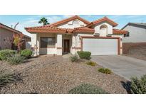 Charming single-story home featuring a desert landscape and a two-car garage at 2455 Silver Blossom Ln, Henderson, NV 89052