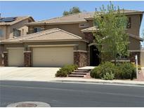 Two story home featuring a three car garage and stone accents at 368 Misty Moonlight St, Henderson, NV 89015