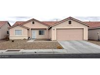 Charming single-story home featuring a two-car garage, low maintenance desert landscaping, and a cozy front porch at 4618 Zia Ridge St, North Las Vegas, NV 89031