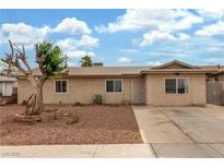 Charming single-story home featuring desert landscaping, a long driveway, and secure gated access in the front at 5109 Gains Mill St, Las Vegas, NV 89122