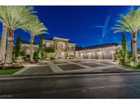 Stunning two-story home with lush landscaping and a spacious driveway with a three car garage at night at 52 Innisbrook Ave, Las Vegas, NV 89113