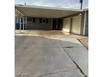Front exterior of home with a covered carport and wide driveway for easy parking at 5804 Balzar Ave, Las Vegas, NV 89108