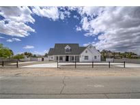 Beautiful two-story home with lush landscaping and a sprawling front yard at 6235 Westwind Rd, Las Vegas, NV 89118