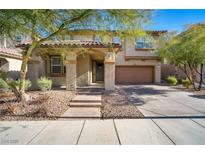 Inviting two-story home with a covered porch, a two car garage, and xeriscaped front yard at 7520 Fontera Ct, Las Vegas, NV 89139