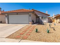 Charming single-story home with a well-maintained front yard and a two-car garage in a residential community at 7728 Barbican Ct, Las Vegas, NV 89147
