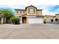 Inviting two-story home with a well-maintained front yard and two-car garage at 7863 Warwickshire Way, Las Vegas, NV 89139
