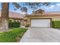 Charming single-story home featuring a two-car garage, tile roof, and mature landscaping at 7988 Harbour Towne Ave, Las Vegas, NV 89113
